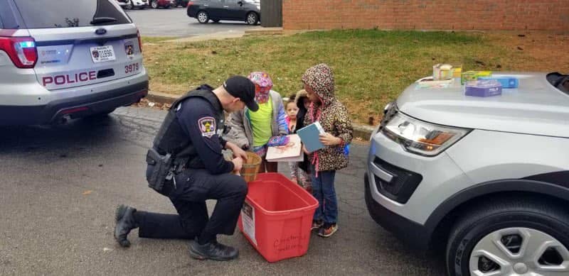 Jeffersontown Police officer helping children during a community service activity
